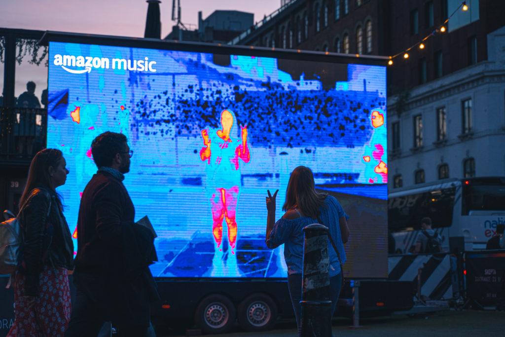 Amazon music heat map screen with woman posing in front